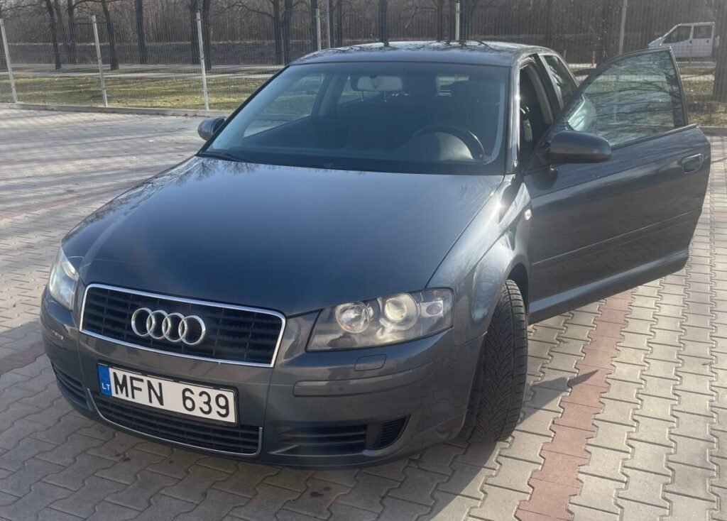 Tamsiai pilkas, tvarkingas Audi A3 Sportback hečbekas automobilių aikštelėje atidarytomis durimis. Brangus Audi supirkimas.